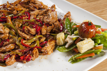 chicken fajitas on serving plate with garniture