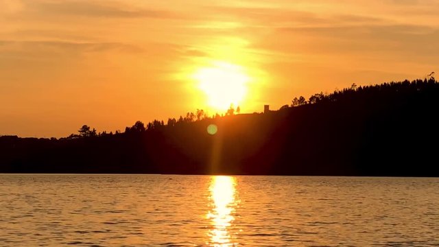 Sunset with warm tones on the river Zezere. Portugal.