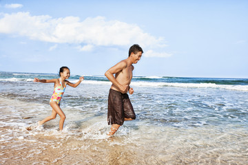 father and daughter at the beach playing