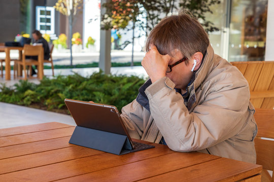Person Outside Looking at their Mobile Tablet