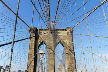 New York, USA - November 22, 2010: The historic Brooklyn Bridge in New York City with US flag