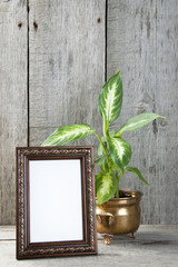 Empty picture frame on wooden background.