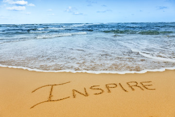 word written in sand on tropical beach