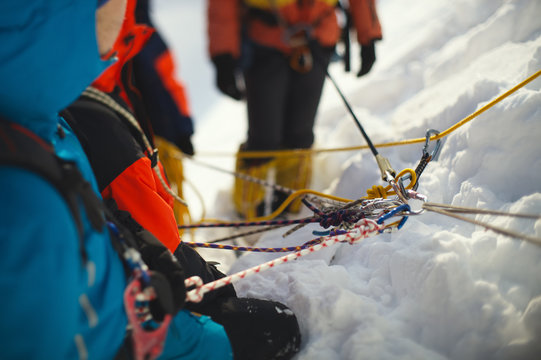 Fall protection mount climbers on the mountain slope, close-up.  Tilt-shift effect.