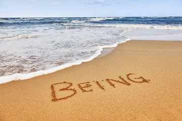word written in sand on the beach