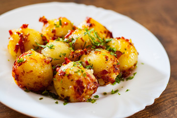 Fresh potato dumpling in white plate on wooden table background
