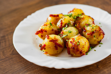 Fresh potato dumpling in white plate on wooden table background