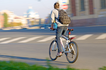 Fototapeta premium Cyclist rides on the road.