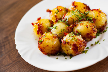 Fresh potato dumpling in white plate on wooden table background