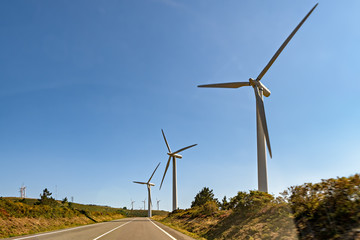 Windmills along paved highway.