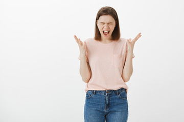 Girl trying calm down, relieving from stress in forest, closing eyes gesturing and shouting,...