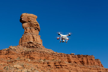 Drone with orange butte and monument in Valley of the Gods in Southeast Utah