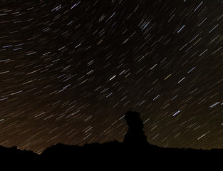 Stars behind a butte in Valley of the Gods in Utah