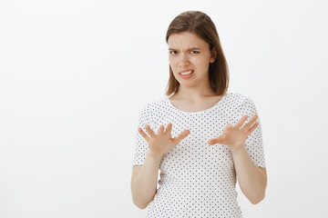 No, take it away from me. Disgusted intense and displeased woman in t-shirt, shaking palms in stop...