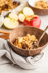 Autumn vegan apple oat crumble pie in coconut bowl.