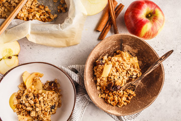 Autumn vegan apple oat crumble pie in coconut bowl, top view.