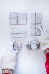 Santa Claus hands putting the gifts