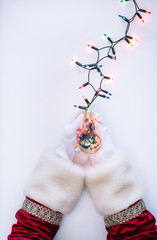 Santa Claus hands putting the lights