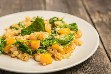 Vegan plate with bulgur and pumpkin.