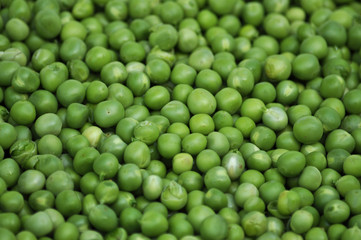 Fototapeta na wymiar A grain of peeled young green peas