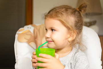 Little girl is drinking tea.