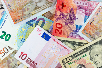 Fototapeta na wymiar Close-up macro photography of dollar, pound, euro and frank. Business money exchange concept background.