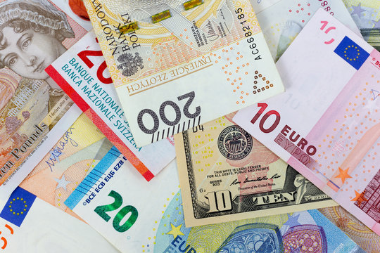 Close-up macro photography of dollar, pound, euro, zloty and frank. Business money exchange concept background.