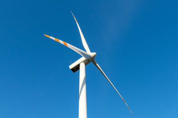 Wind turbine against blue sky. Wind energy. Eco concept.