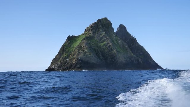 Approaching the Irish island Skellig Michael with a boat