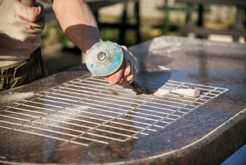 a man works with a marble slab with a hammer and chisel. working man hard work. marble products.