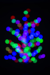 Christmas tree made with blurred colored light bulbs