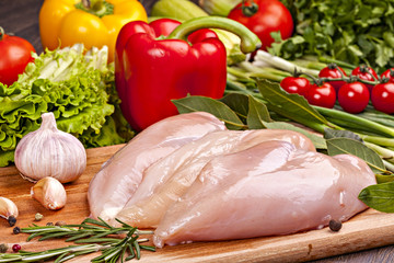 Fresh chicken meat for cooking  with vegetables, spices and herbs.