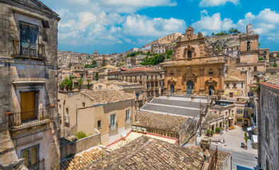 Scenic sight in Modica with the Cathedral of San Pietro and the Duomo of San Giorgio in the background. Sicily, southern Italy. - obrazy, fototapety, plakaty