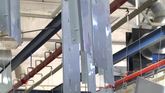 Automatic powder coating line. Powder coating of metal parts. Powder coating of metal parts with thermal polymerization paint.
