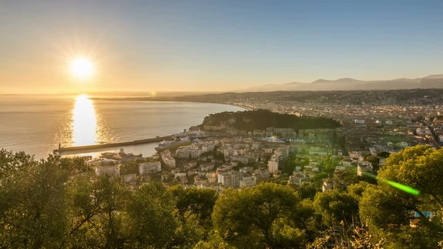 Nice, southeast France. Sunset, city skyline and Mediterranean Sea scape. Panoramic view from Mont Baron towards the Port of Nice. Time lapse video.