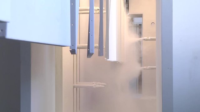 The process of applying powder coating on metal parts. Automatic powder coating line. Powder coating of metal parts. Powder coating of metal parts with thermal polymerization paint.