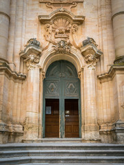 Obraz premium Ornate door to the Duomo of San Giorgio in Modica, fine example of sicilian baroque art. Sicily, southern Italy.