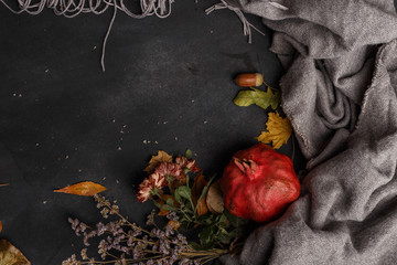 Autumn composition of dry leaves, fruits and flowers on a dark background. Top view. Copy space
