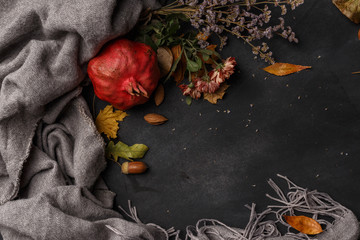 Autumn composition of dry leaves, fruits and flowers on a dark background. Top view. Copy space