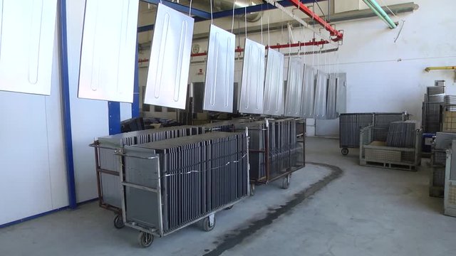 Automatic powder coating line. Powder coating of metal parts. Powder coating of metal parts with thermal polymerization paint.