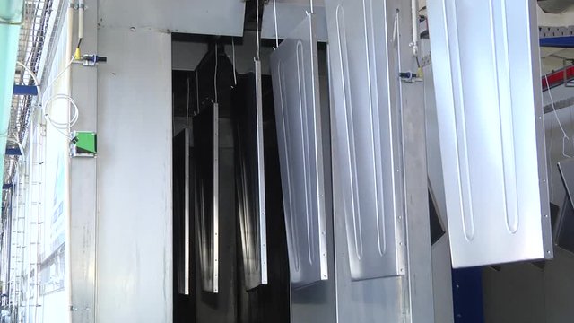 Automatic powder coating line. Powder coating of metal parts. Powder coating of metal parts with thermal polymerization paint.