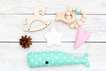 Wooden baby toys and wooden baby teether. Flat lay cozy