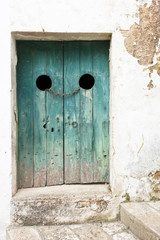 Specchia, Apulia - An old wooden door tightened with a steel track