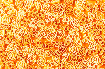 Halloween tricolore pasta on orange background,minimal food concept.