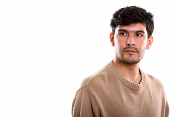 Fototapeta premium Studio shot of young Persian man thinking while looking at dista