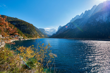 Fototapeta na wymiar Colorful autumn landscape with mountains, lake and trees in Austrian Alps. Salzkammergut, Gosausee