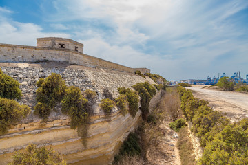 Marsaxlokk, Malta. The fortress wall and dry moat of the British Fort Delimar, 1876 - 1888