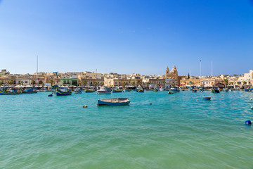 Fototapeta na wymiar Marsaxlokk, Malta. Scenic view of the city from the bay