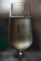 Misted glass of champagne with drops