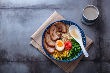 Ramen noodles in tonkotsu broth, top view, copy space